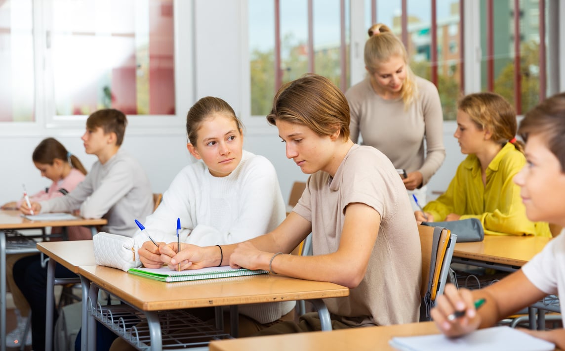 Group of school kids and teacher during lesson